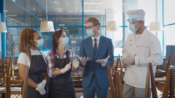 Cafe Staff and Manager on Morning Briefing Wearing Protective Masks and Gloves Work During