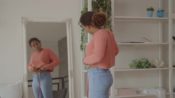 African Woman Upset with Measurement of Waist