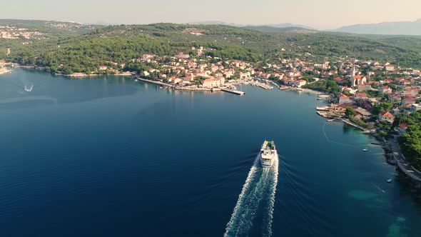 Aerial view of ferry boat approaching Sumartin port, Brac island, Croatia.