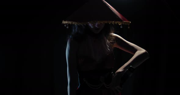 Dangerous Geisha in Red Hat and a Dress Is Taking Katana Out of the Sheath