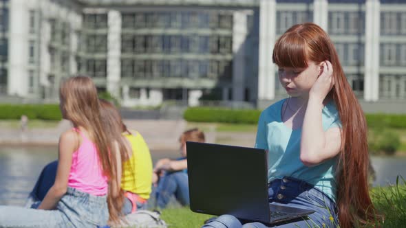 Portrait of Caucasian Teen Girl with Laptop in Park