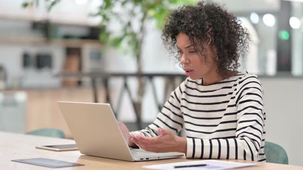 African Woman Reacting to Failure on Laptop in Office