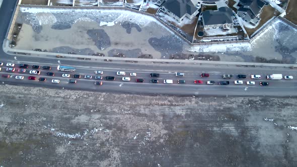 Traffic on a busy street and intersection at rush hour during dusk - aerial time lapse