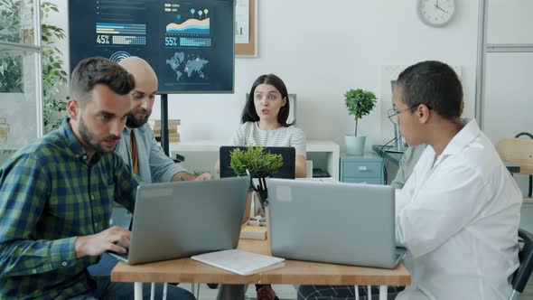 Group of Businesspeople Working Talking Using Computers Then Throwing Paper Balls and Having Fun