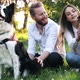 Beautiful Couple Cuddling and Walking Dogs Outdoors - VideoHive Item for Sale