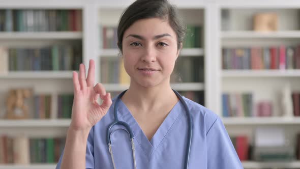 Portrait of Indian Female Doctor showing Ok Sign with Finger