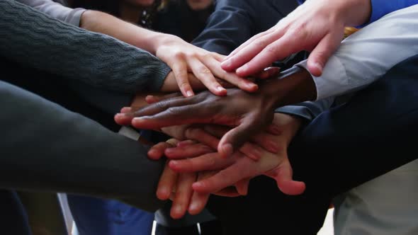 Businesspeople forming hands stack