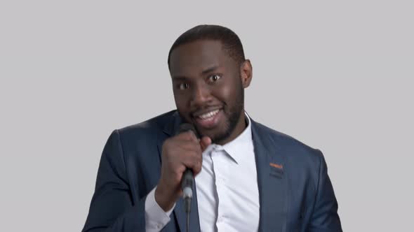 Black Handsome Man Is Singing in Microphone.