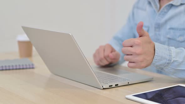 Thumbs Up By Man Typing on Laptop Close Up