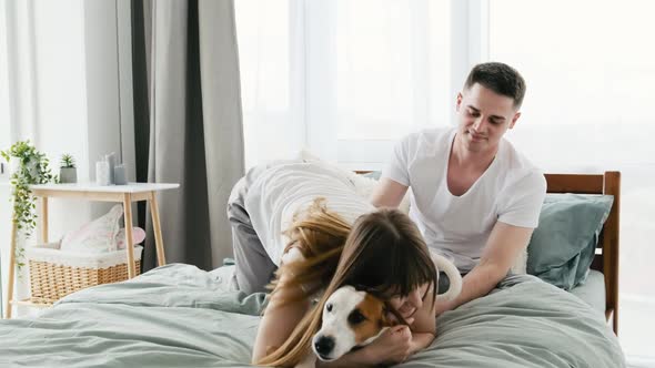 Couple with Dog in the Bed