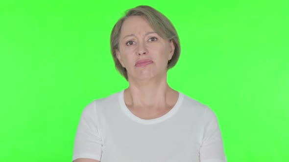 Disappointed Old Woman Reacting Loss on Green Background