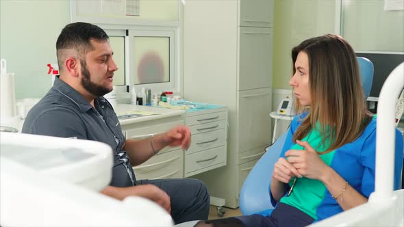 Dentist Talking to the Woman Patient