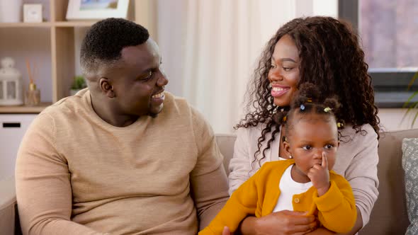 Happy African Family with Baby Daughter at Home