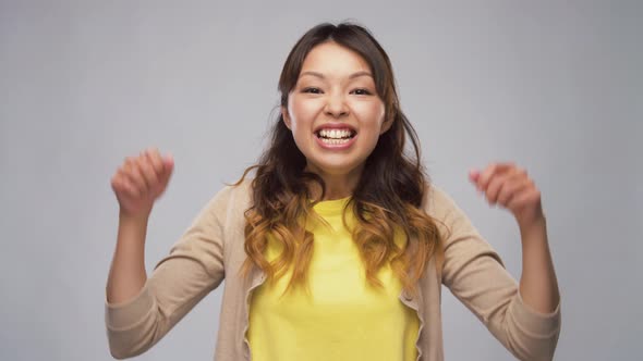 Happy Asian Woman Celebrating Success