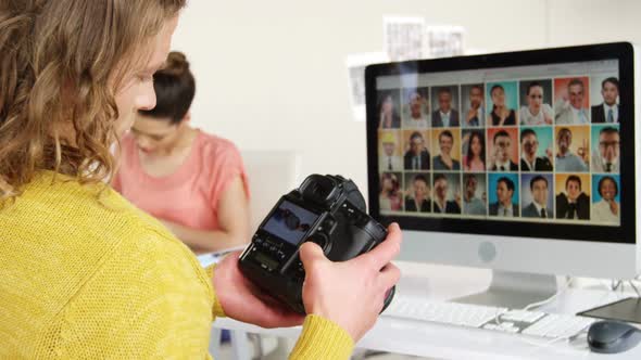 Photographer looking at photos on digital camera