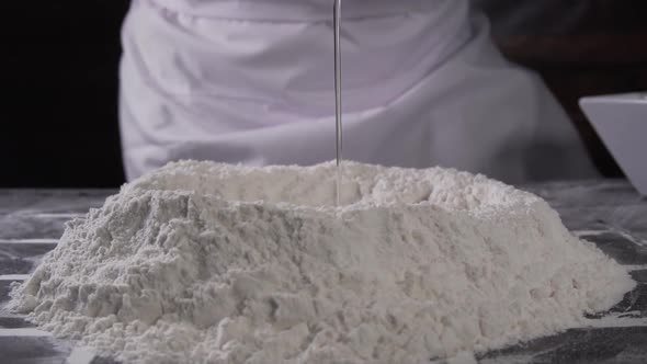 chef pouring an egg onto flour