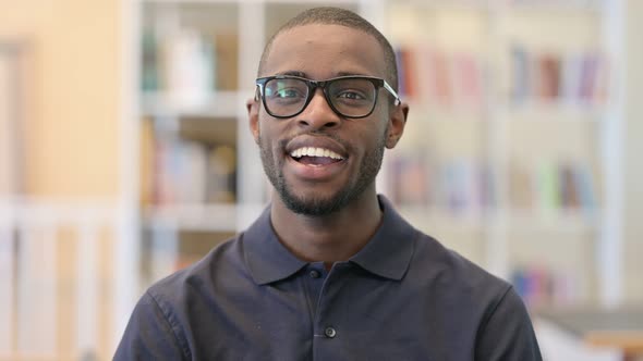 Portrait of Cheerful Young African Man Talking on Video Call