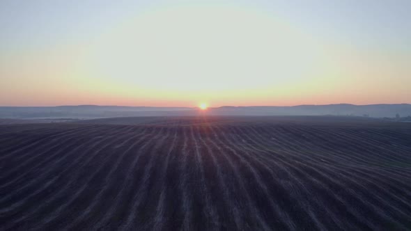 Sunrise On The Field. Earth Close Up. Bright Rays Illuminate The Earth