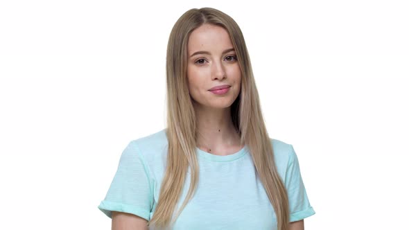 Portrait of Gorgeous Woman 20s with European Appearance in Basic Tshirt Smiling at Camera Isolated