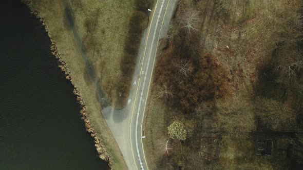 Bicycle path near the city reservoir. Aerial photography. Shot camera down.