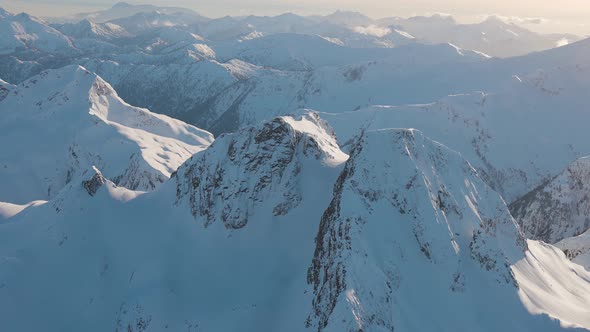 Aerial View From an Airplane of Beautiful Snowy Canadian Mountain Landscape