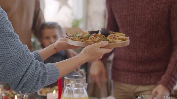 Unrecognizable People Setting Table Together