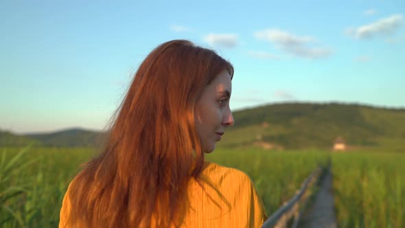 Woman with red hair walking