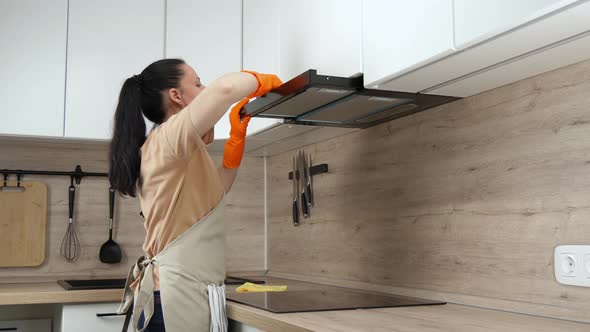 Cleaning company. A woman cleans, cleans, washes in the kitchen. House cleaning. cleaning specialist
