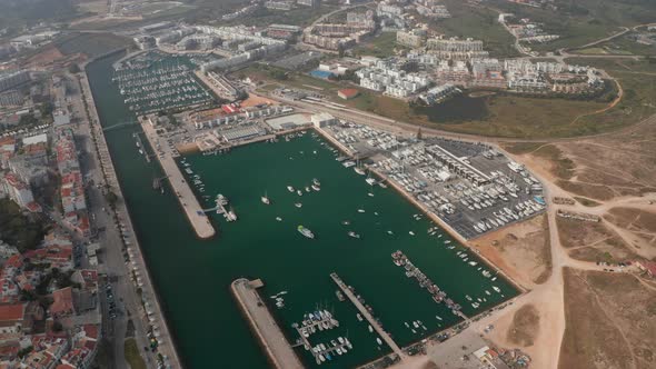 Aerial Drone View of Avenida Dos Descobrimentos Promenade Street with Boats in Marina Port Lagos
