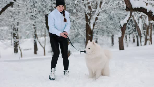 Girl with Dog in the Park in Winter