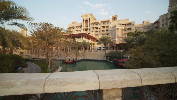 Small Wooden Boat Driving Down the Water Canal in Luxury Hotel Resort in Dubai