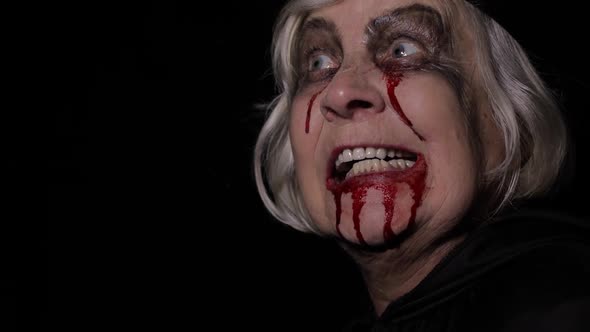 Old Witch Halloween Makeup. Elderly Woman Portrait with Blood on Her Face