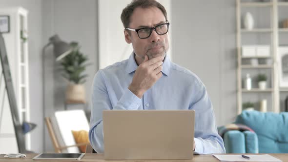 Senior Aged Businessman Thinking at Work