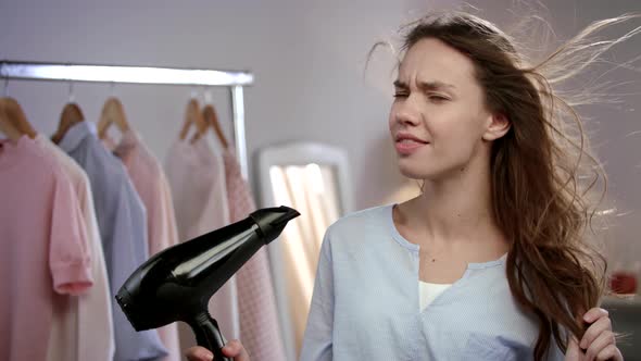 Joyful Woman Singing in Hair Dryer