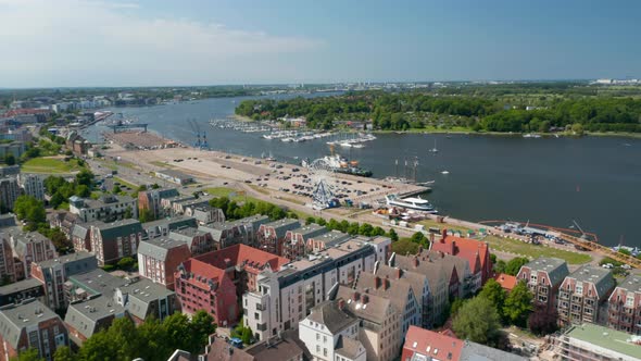 Aerial View of Coastal Urban District with Various Colourful Houses and Large Parking Lot with