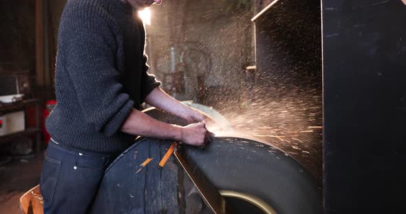 Bladesmith wet grinding a blade