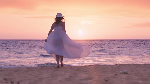 Silhouetted Happy Young Woman Running By Ocean Beach Scenic Golden Pink Sunset