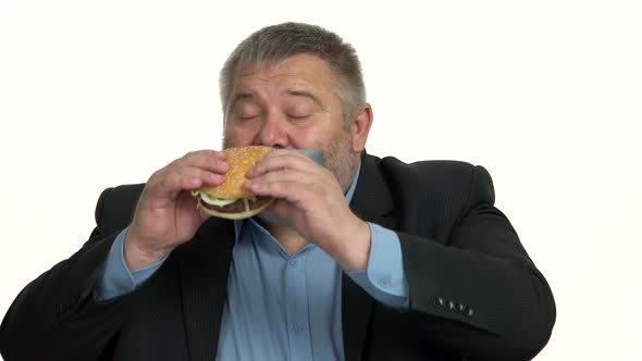 Businessman with Taped Mouth Can Not Eating Junk Food