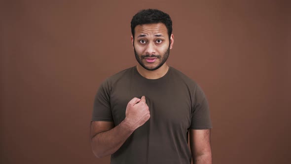 Studio Portrait of Indian Man Pointing at Himself with Question Me and Nodding Head in Agreement