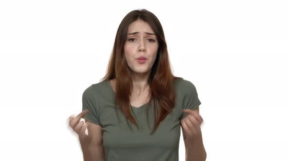 Portrait of Brunette Annoyed Woman 20s in Casual Tshirt Gesturing in Furious Manner and Asking What