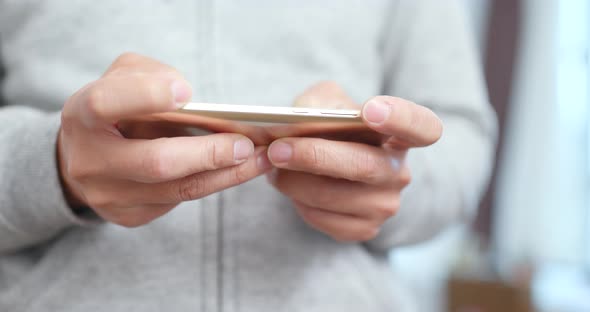 Man sending sms on smart phone