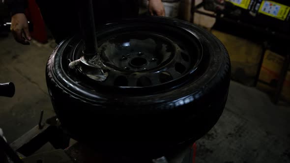 repair mounting tire and inflate air with special device at service station. Replacement of car tire