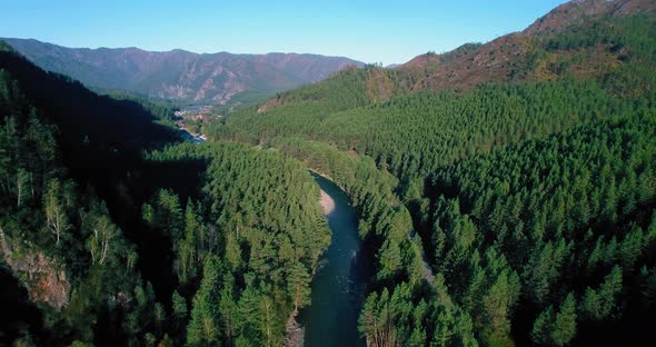 Low Altitude Flight Over Fresh Fast Mountain River with Rocks at Sunny Summer Morning.