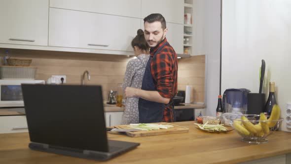 Young Happy Family Preparing Dinner at Home Kitchen