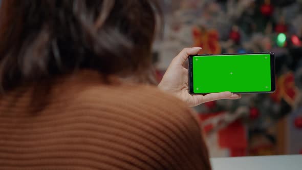 Young Woman Using Green Screen Smartphone