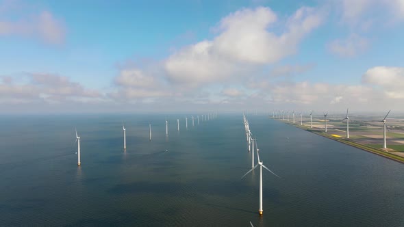 Offshore Windmill Park with Clouds and a Blue Sky Windmill Park in the Ocean Drone Aerial View with