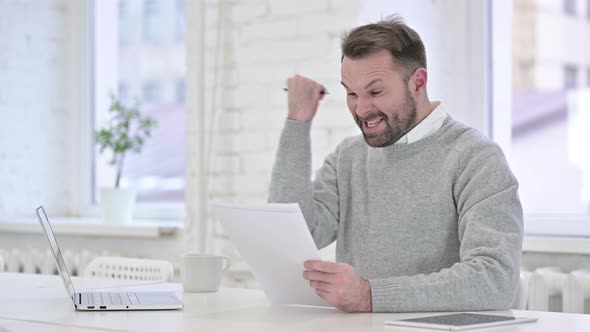 Excited Man Celebrating Contract, Reading Documents