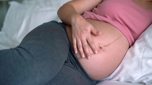 Happy Pregnant Woman and Expecting Baby at Home