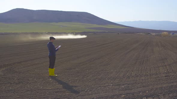 Tractor agrochemical Agricultural spraying. Modern farmer tablet use.