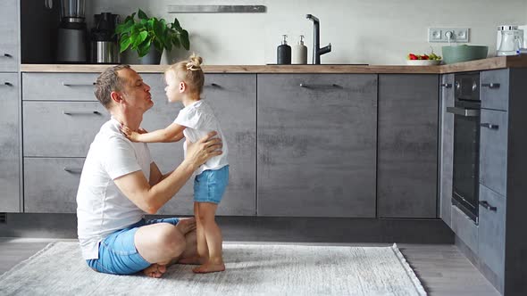 A Happy Father and Little Girl Joyfully Spending Time in a Modern Kitchen